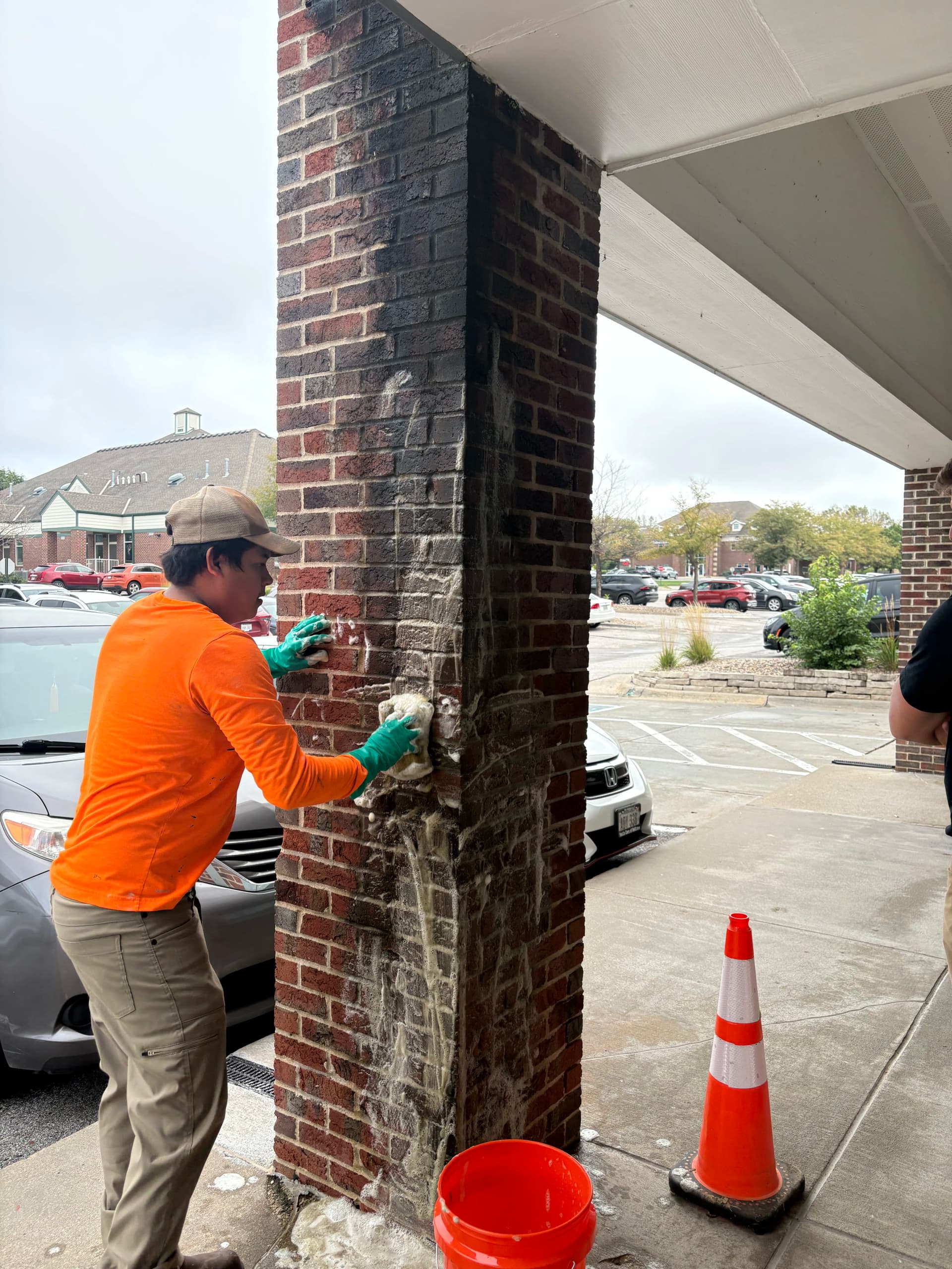 Hand-Washing Water Stains Off Commercial Brick Pillars image